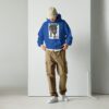 A man in blue hoodie and brown pants.